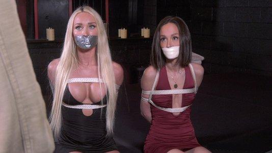 Wearing Sexy Dresses, Helpless Reporters Meagan And Christina Struggle Side By Side, Gagged With Tape, As They Compete For The Prized Interview With The Mysterious Mr. Savage! 1080p Version